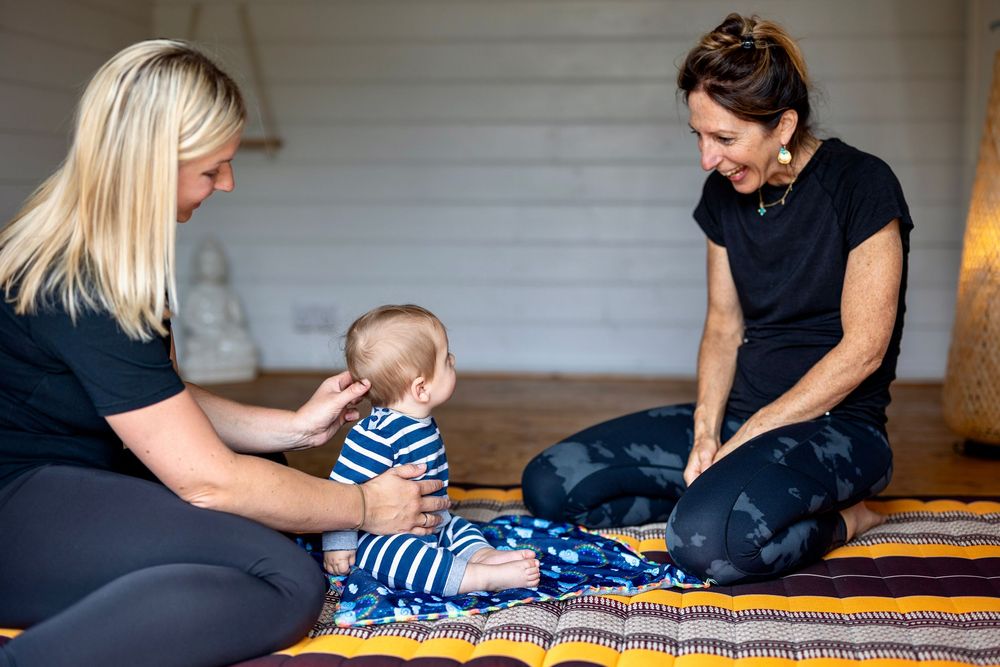 Massage practitioner with client and baby business branding photo, Corsham, Wiltshire.