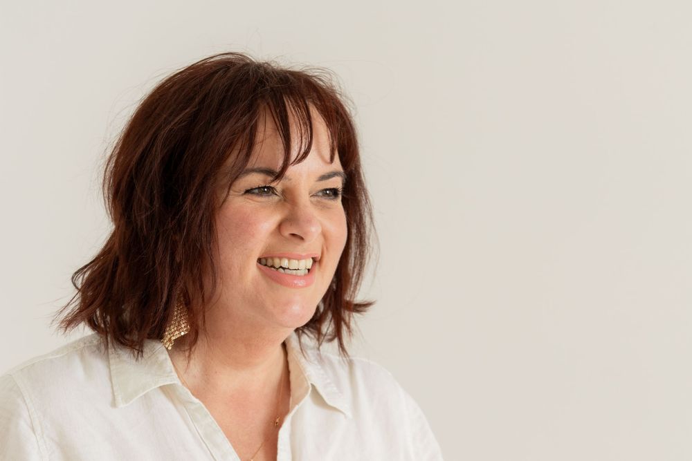 Portrait of a woman smiling at a Chelsea wedding photographer off camera
