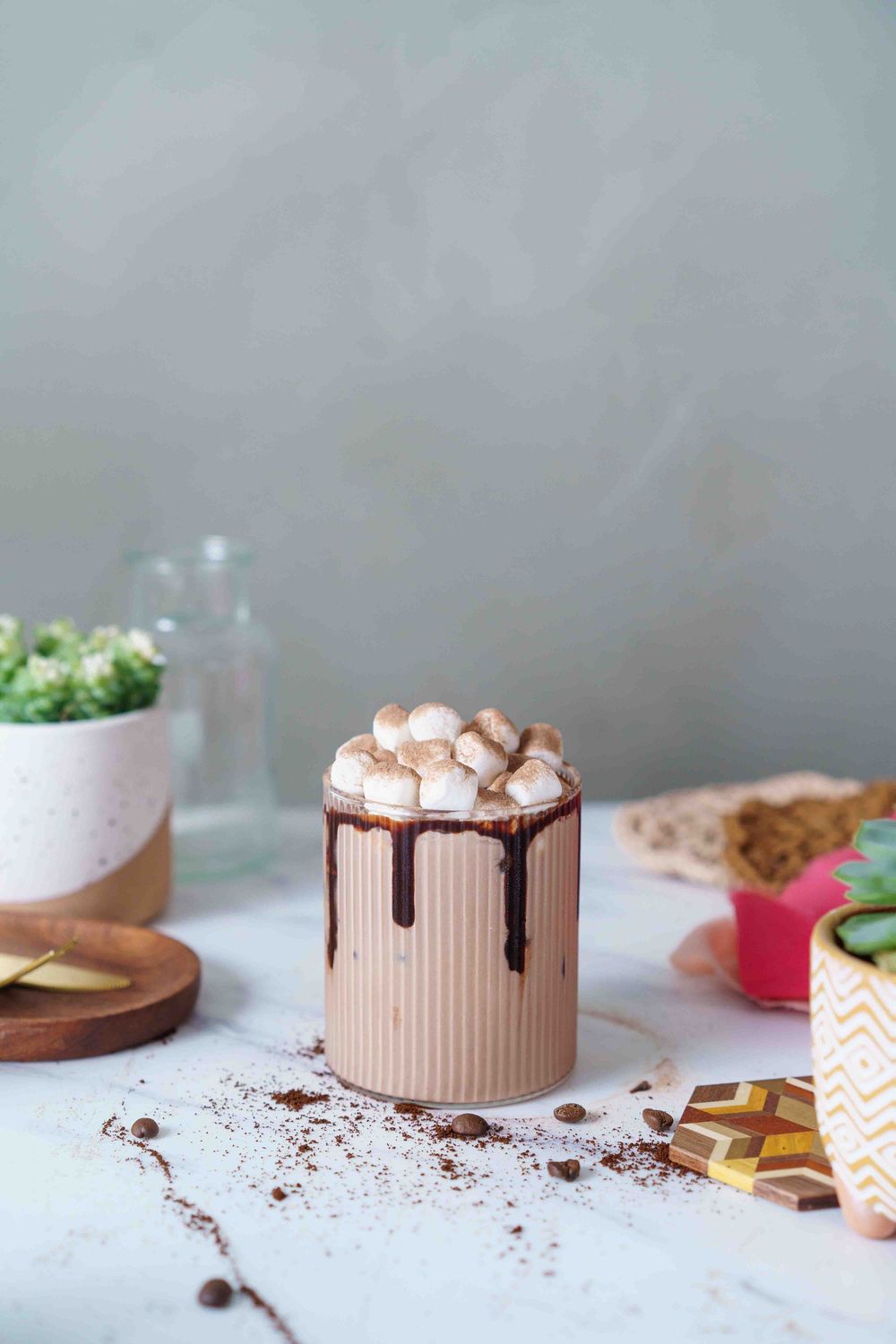 Chocolate cake with marshmallow topping photographed in sequence showing various stages of decoration and assembly.