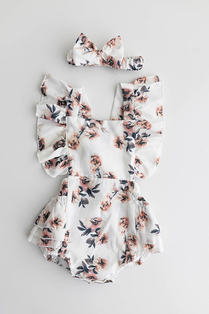White floral print ruffle sleeve baby romper for 1 year old baby girls photoshoot.