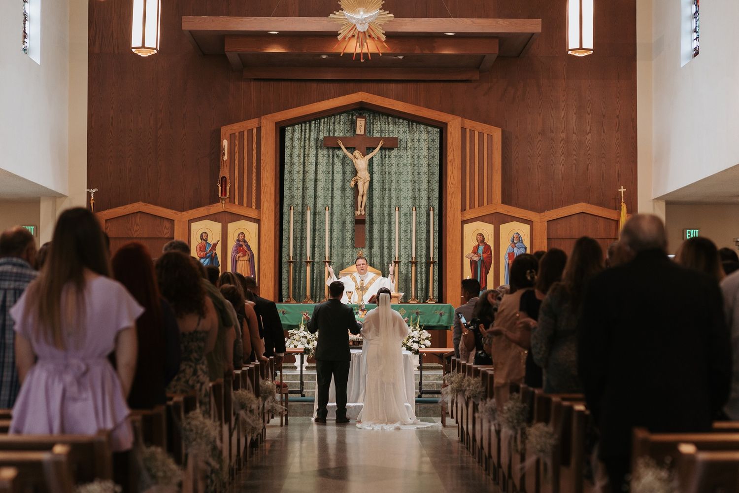 A traditional church interior with wooden beams and pews during a wedding ceremony in Escondido, California.