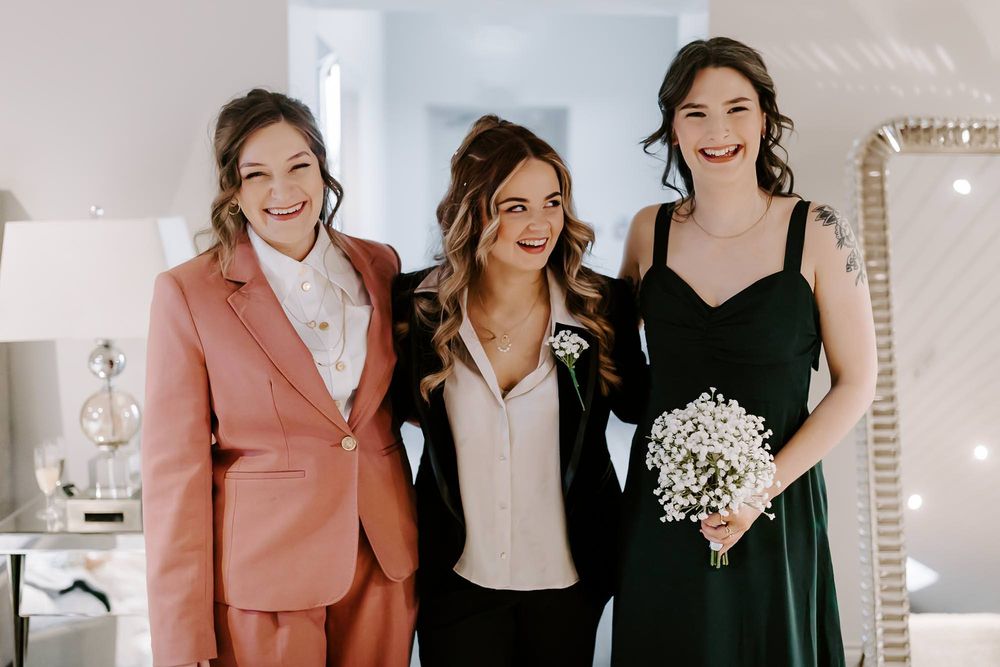 Group of people sharing joyful moments and laughter in a bright indoor setting.