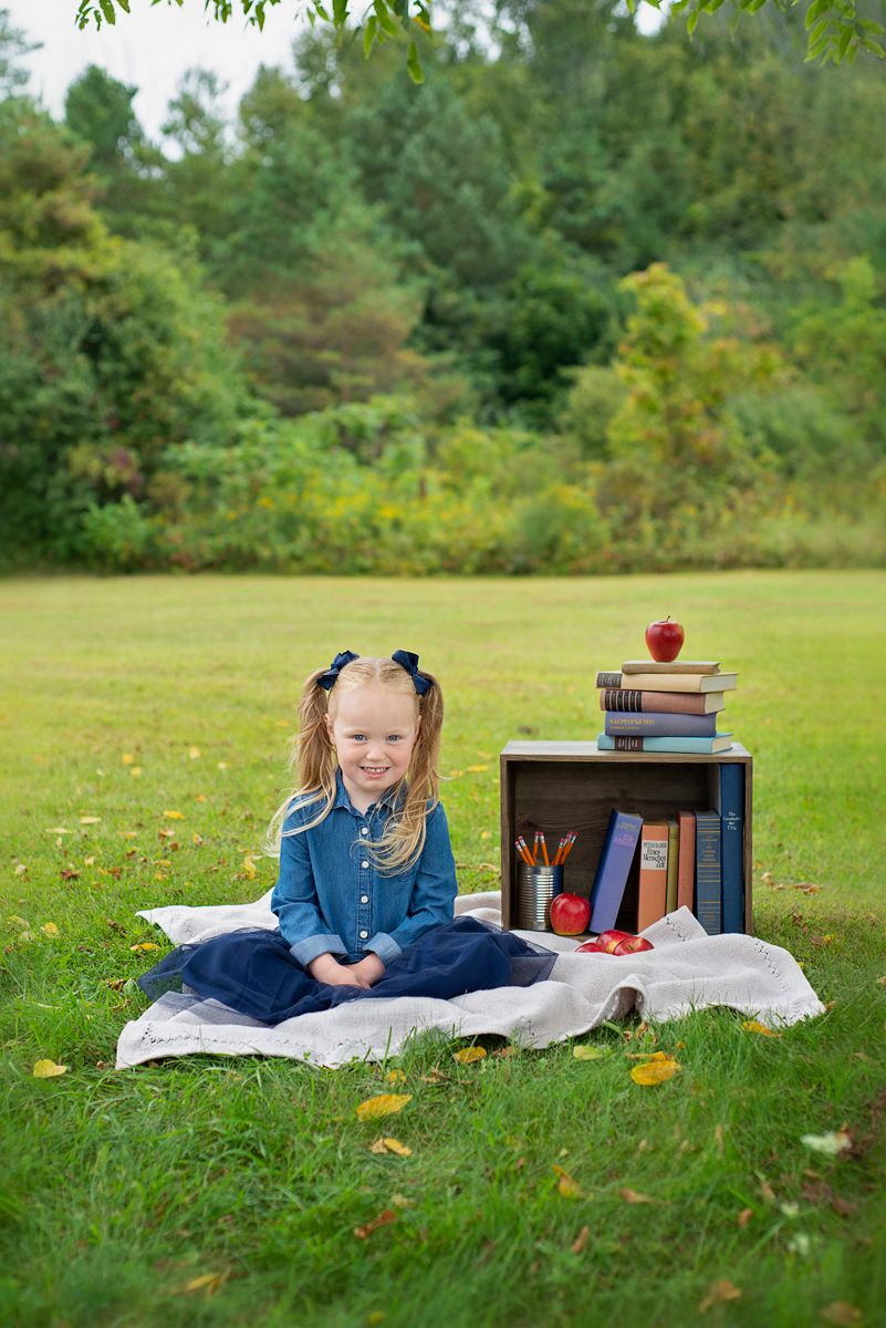 Young girl ready for back to school with green trees, and open fields in background, outdoors at Baltimore Community Centre, Baltimore