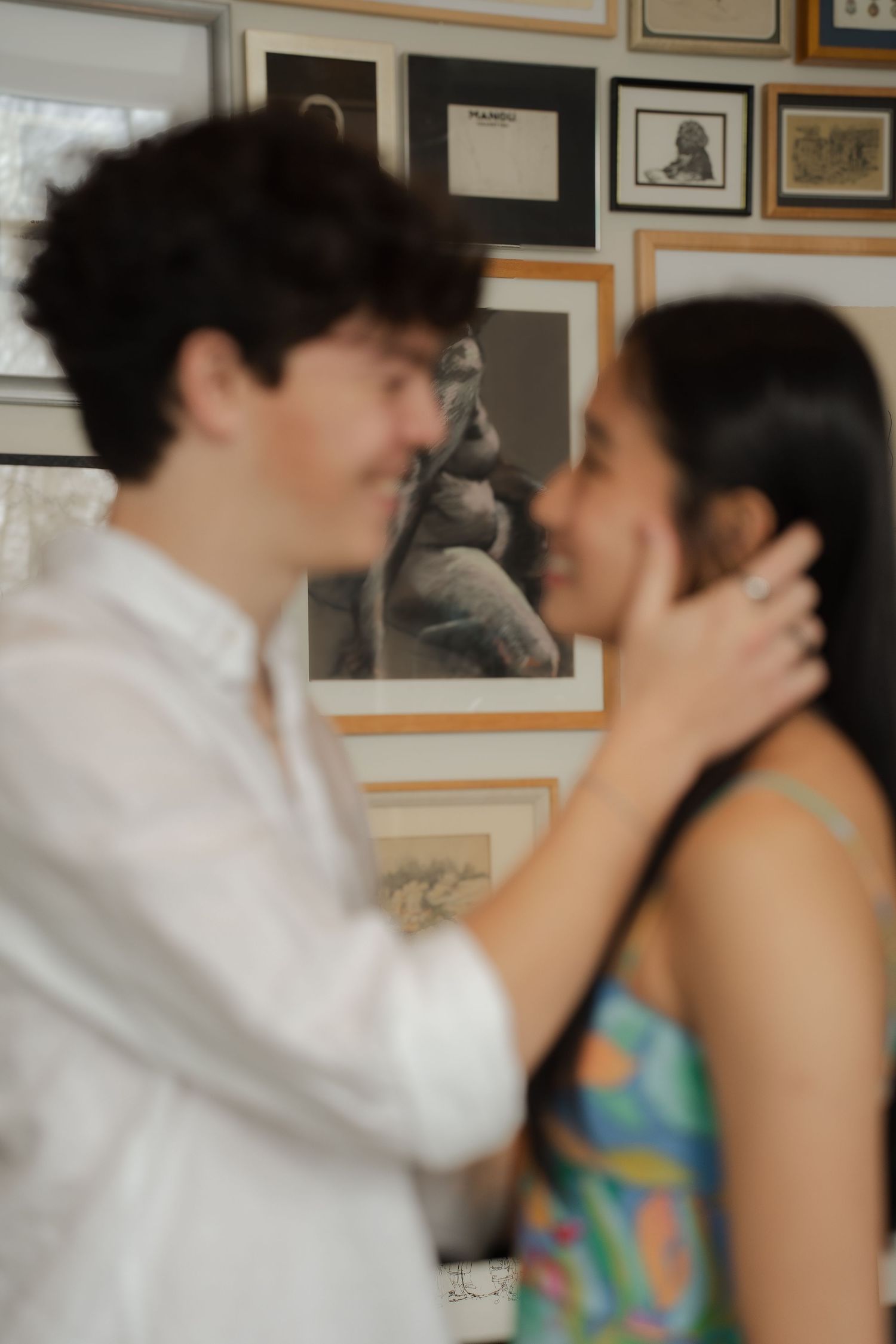 An intimate sequence of photos showing a couple in a hallway with framed artwork.