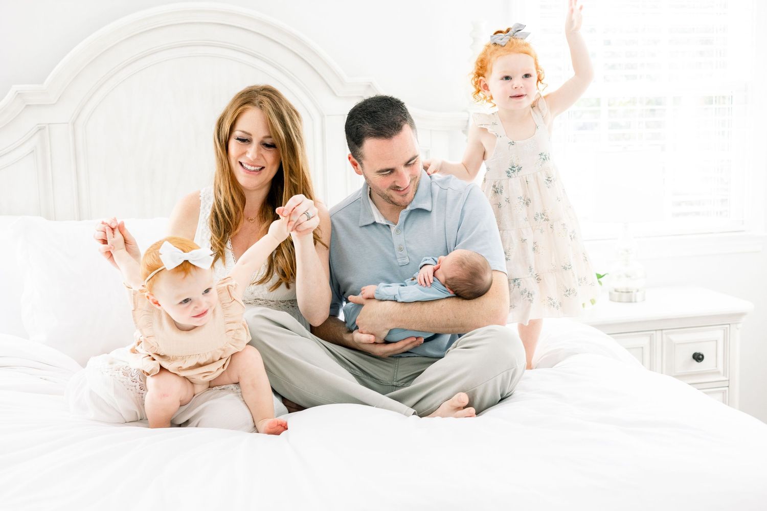 Mom in soft flowing dress holding newborn in Augusta in-home session