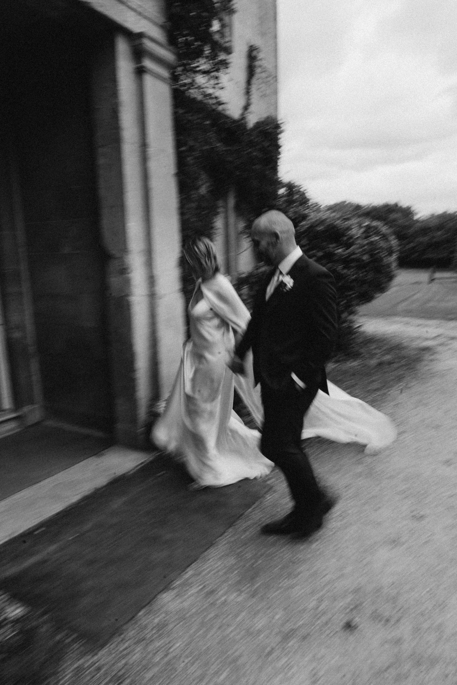 A sequence of black and white photos showing a figure in motion falling to the ground in a dramatic fashion at a Cotswold wedding venue