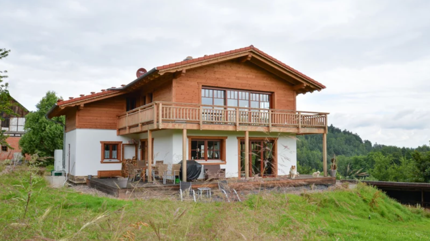 A panoramic collage showing exterior and interior views of a modern modular home with orange trim and beige siding.