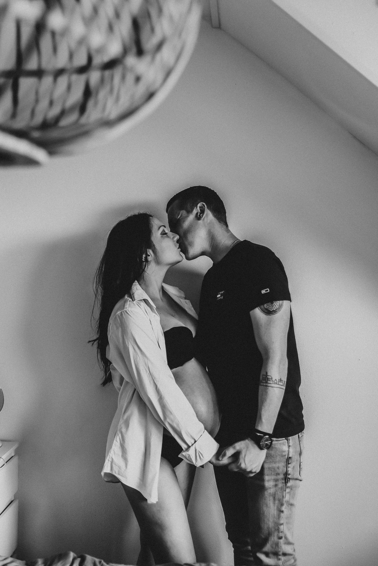 Intimate black and white photo capturing a romantic moment between couple.