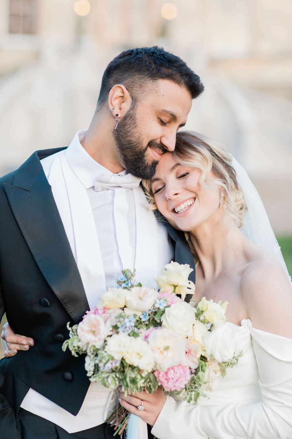 Wedding portrait with couple embracing outside of Botleys Mansion by Maddie Waters Hampshire Photographer