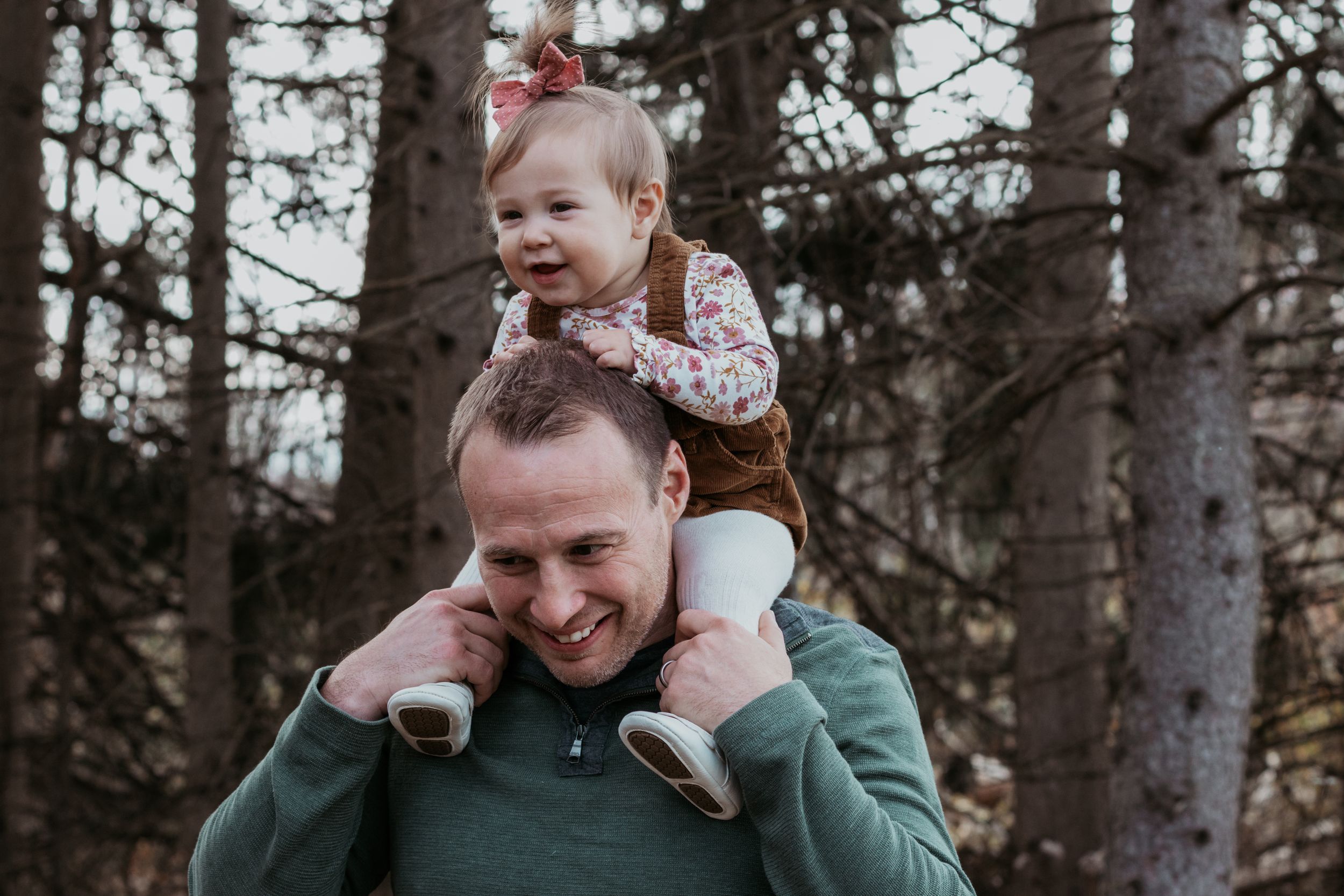 Loving family interactions during an outdoor photo session among trees.