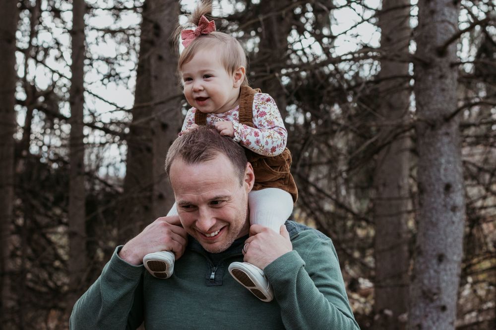 Loving family interactions during an outdoor photo session among trees.