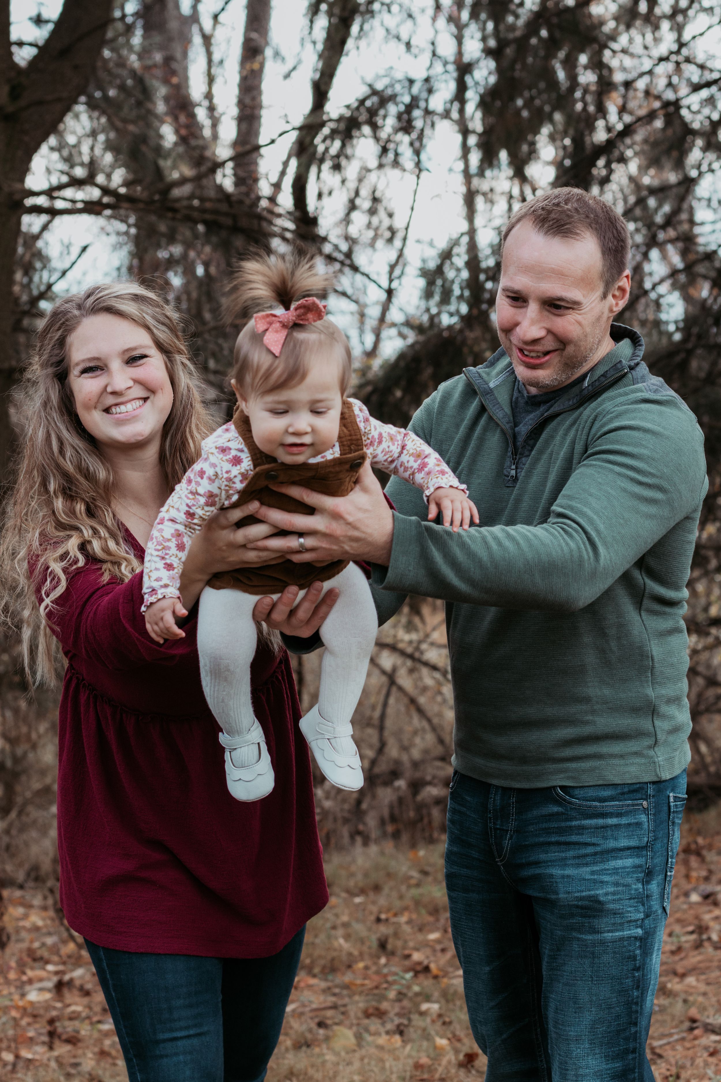 Sequence of joyful family moments captured in a wooded outdoor setting.