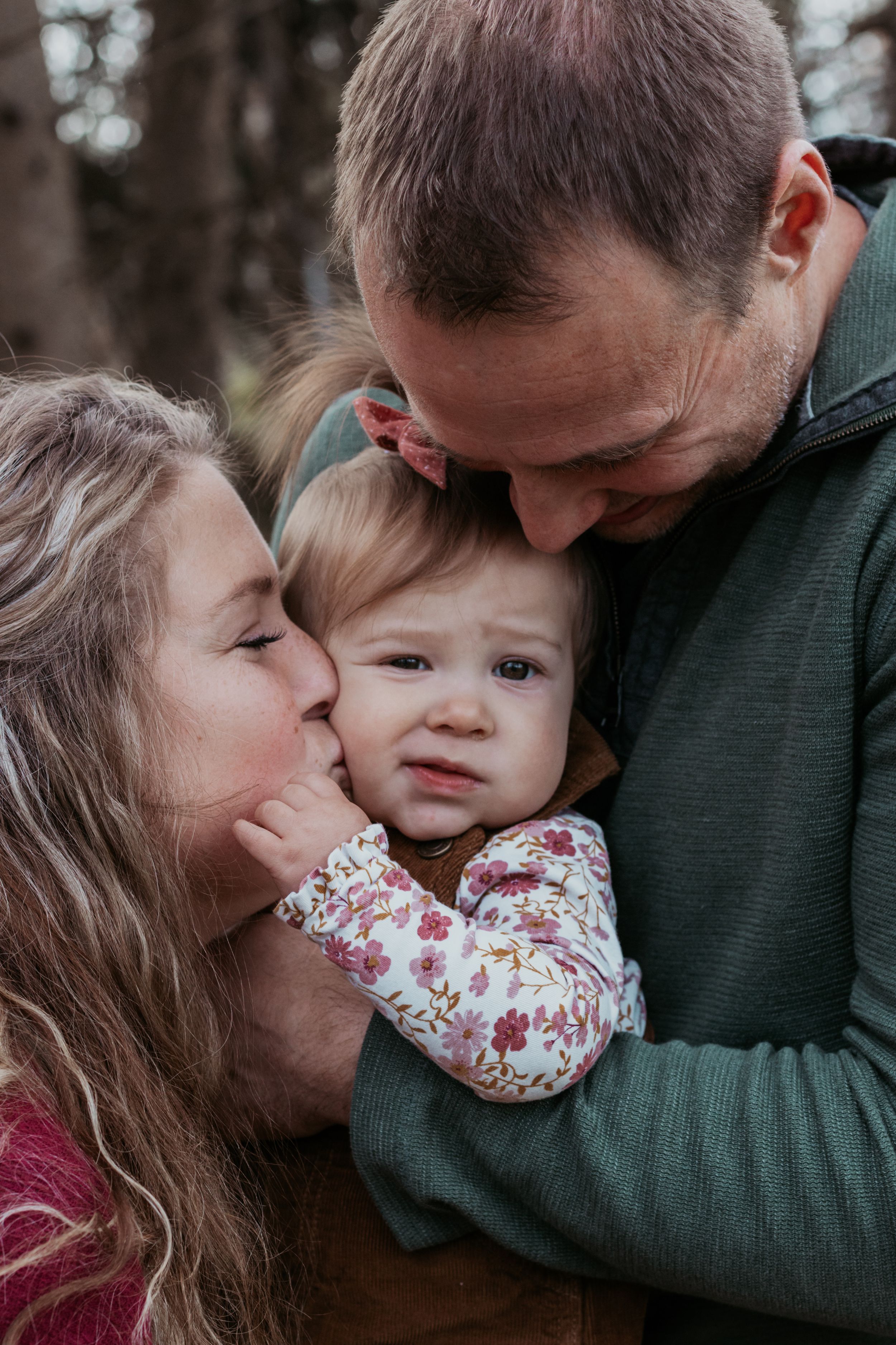 Intimate family moments captured in close-up shots during an outdoor session.