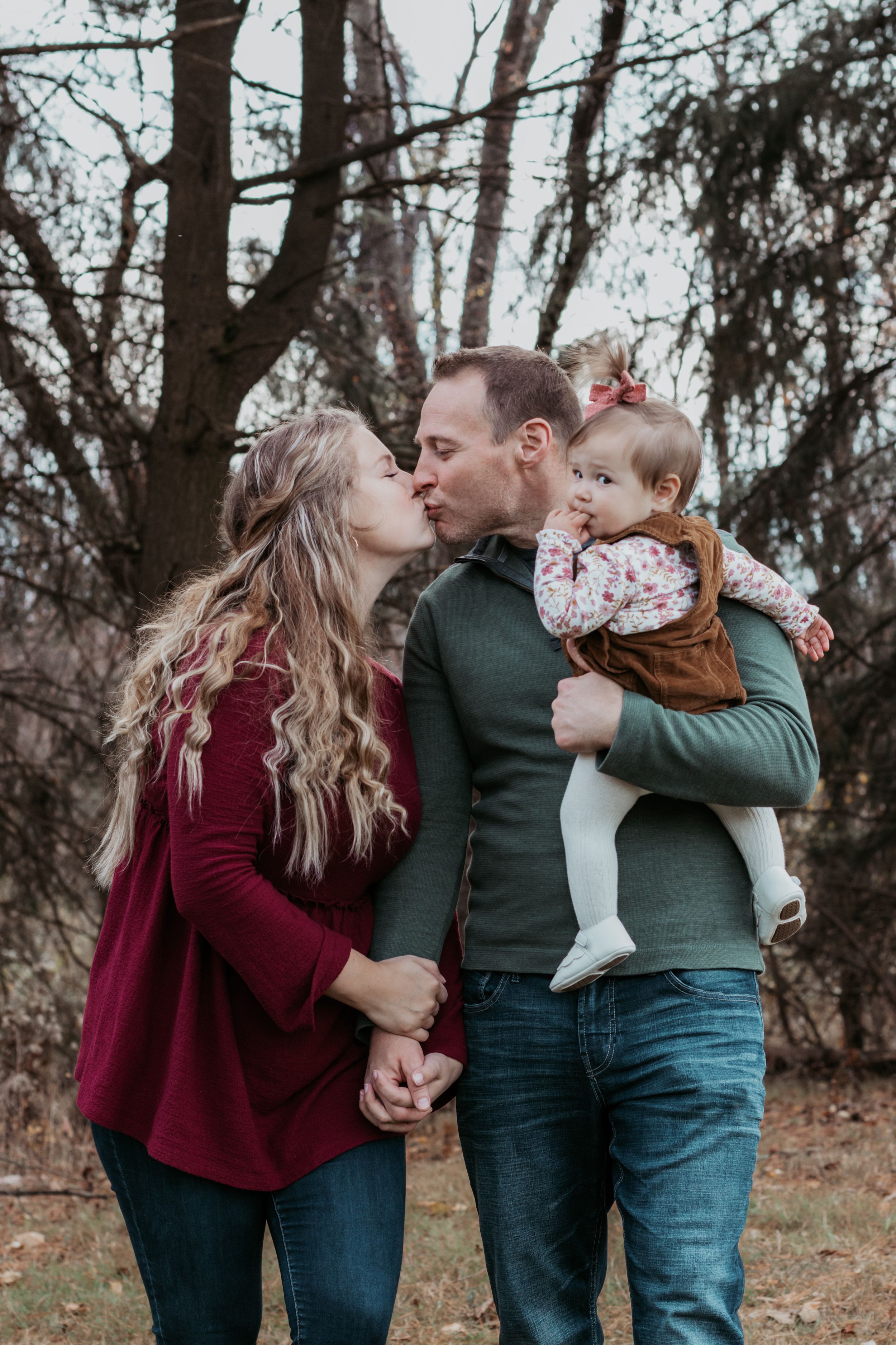 Natural family photo sequence showing affectionate moments in a forest setting.