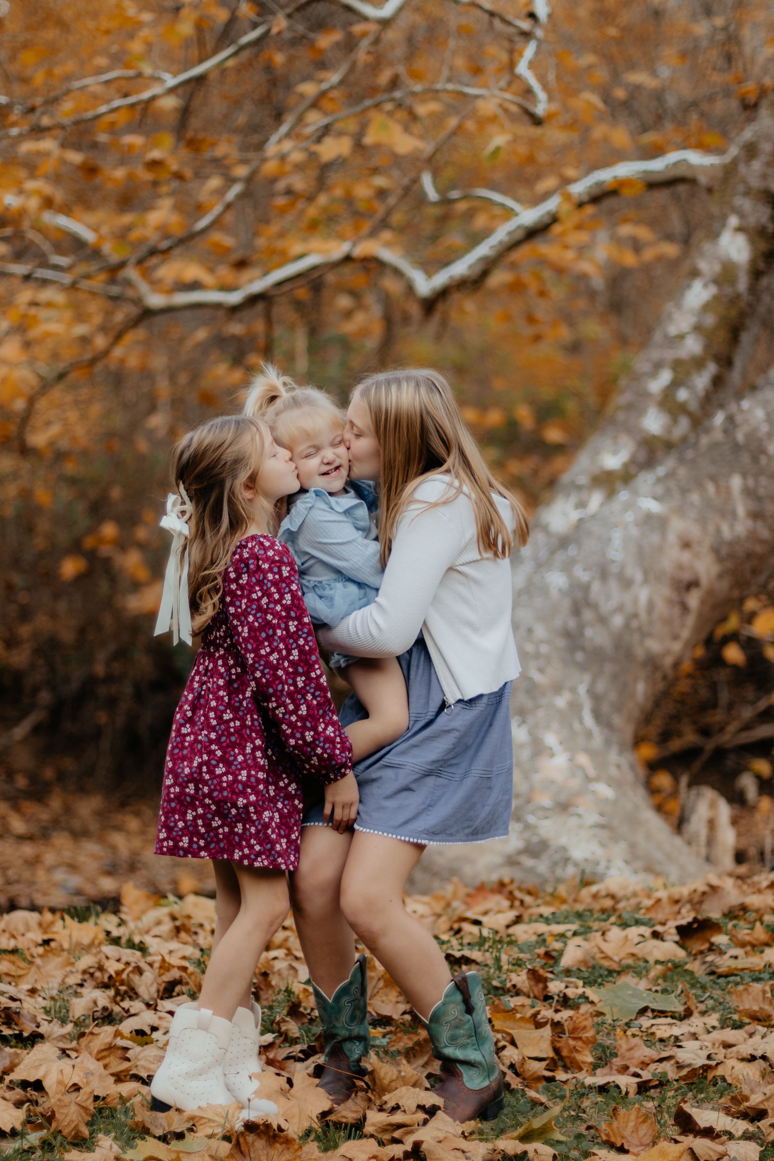 Playful moment captured between children in autumn setting with fallen leaves.