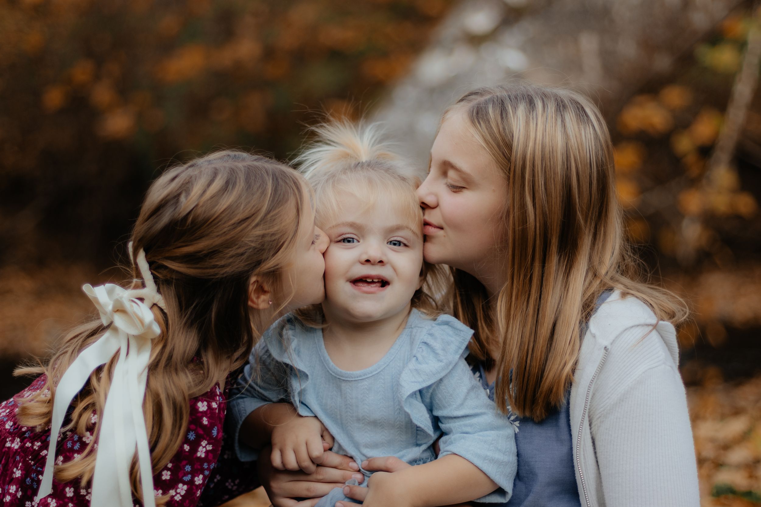 Close up of joyful expressions during autumn family photoshoot.