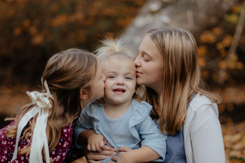 Close up of joyful expressions during autumn family photoshoot.