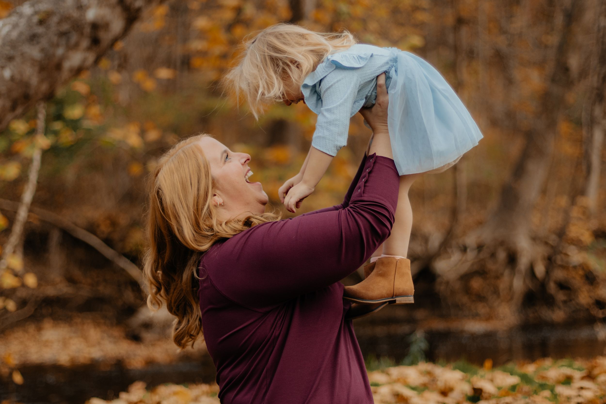 Joyful moments captured during an autumn family photoshoot with warm fall colors.