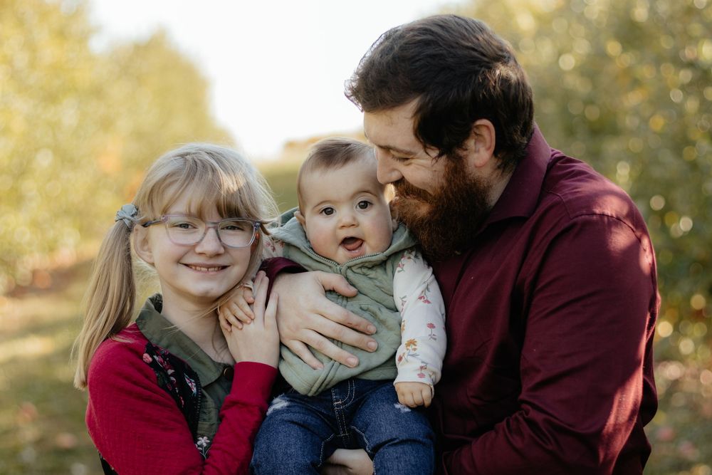 Intimate family portrait session with warm autumn colors and natural lighting.