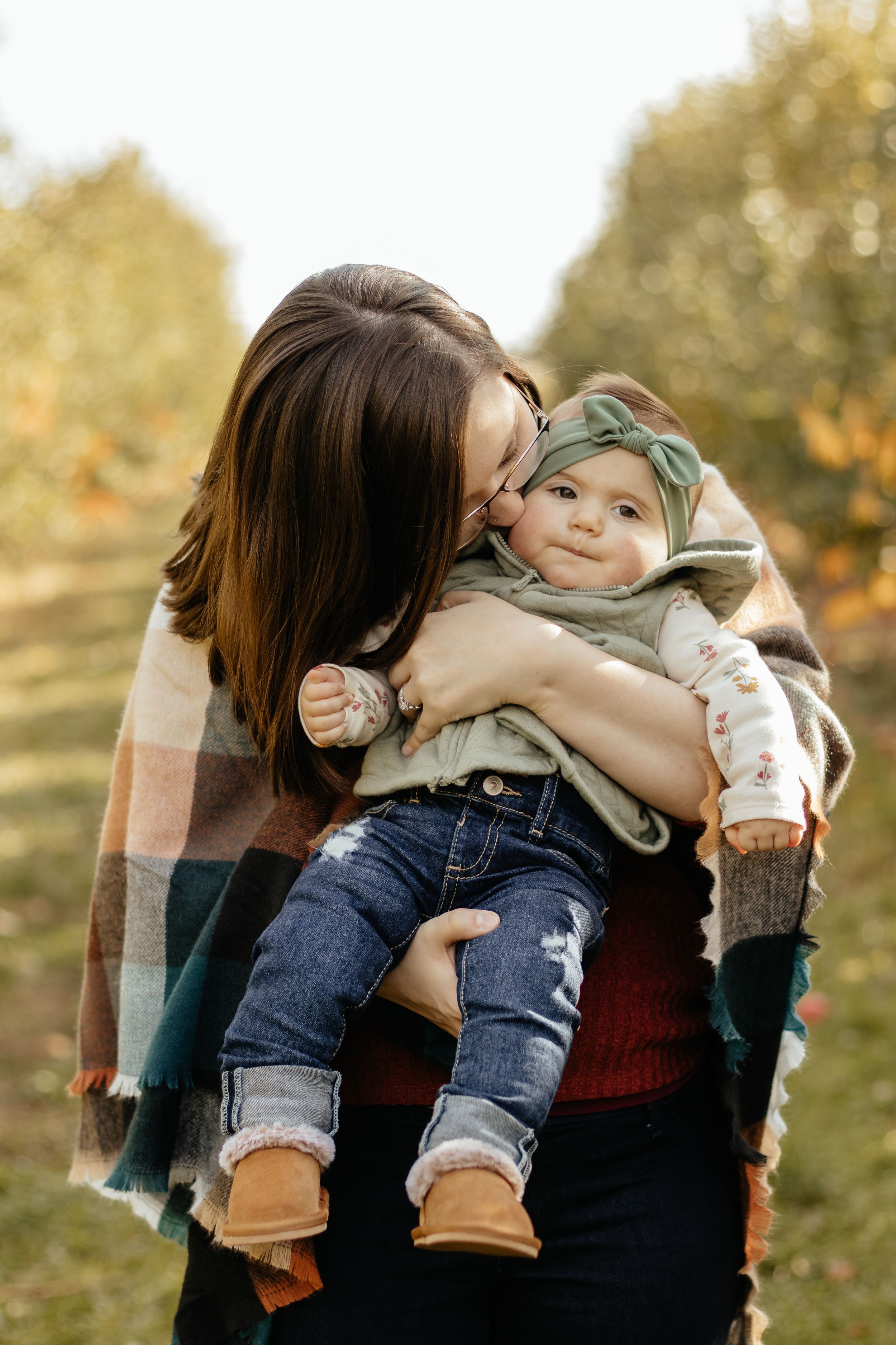 Playful family moments captured in sequence showing joyful interaction on grassy hill.