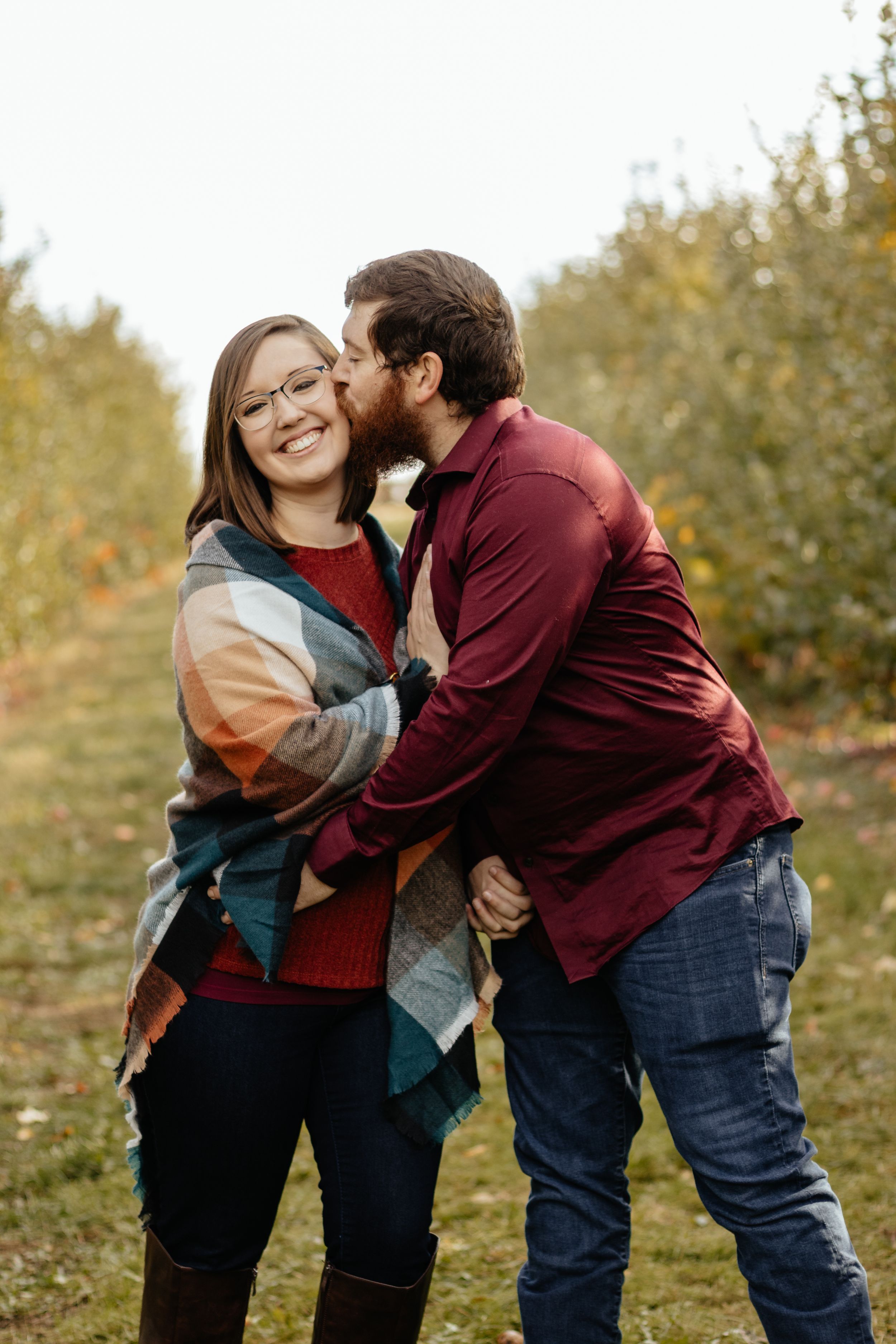 Candid sequence of couple sharing affectionate moments outdoors in autumn setting.