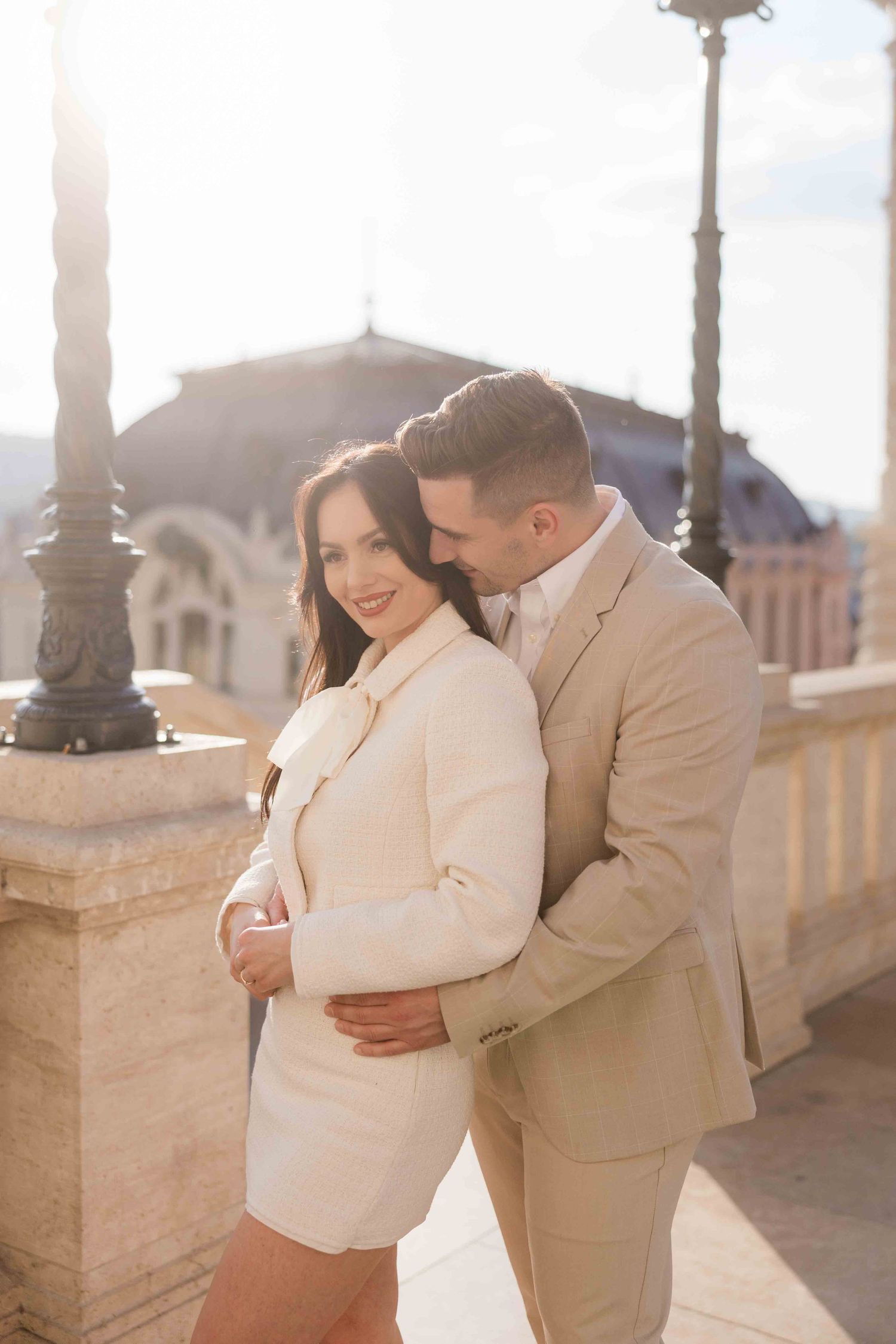 Elegant couple walking in Buda Castle during sunrise photoshoot