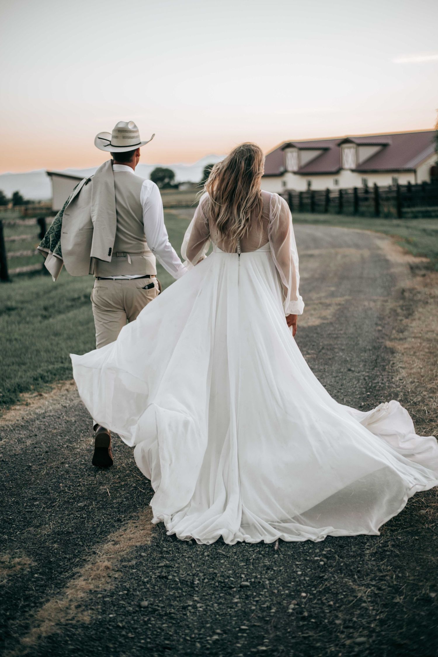 Ellensburg, WA wedding couple walking away from the camera in wedding attire.