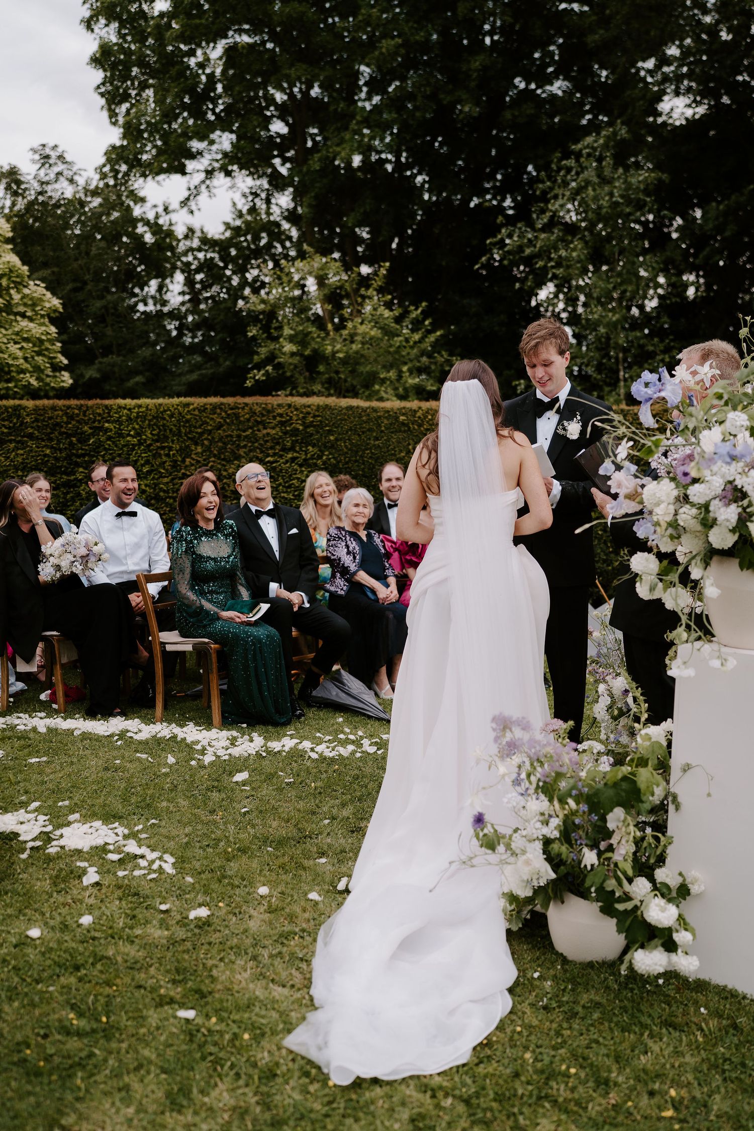 groom crying while reading vows and guests laughing during wedding ceremony at dewsall court in herefordshire