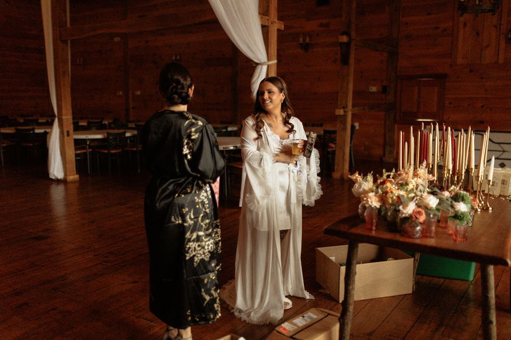 A romantic barn wedding ceremony setup with rustic wooden decor and glowing candlelight.