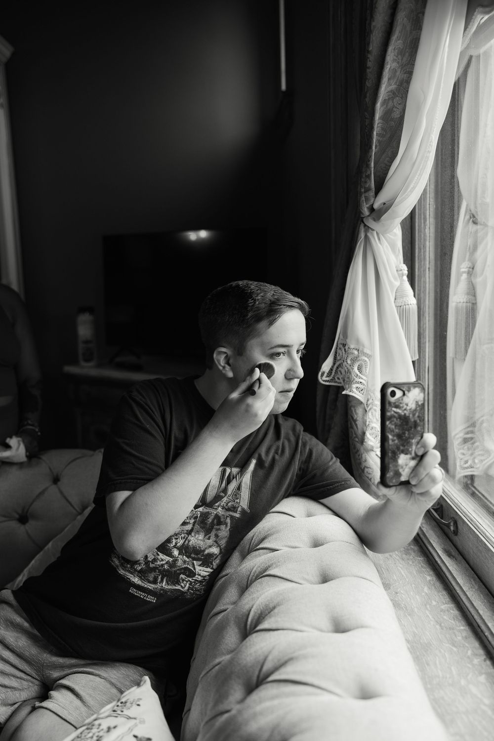 Black and white photo sequence showing someone taking selfies near a window with natural light.