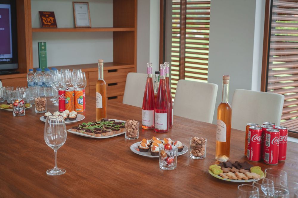 A series of restaurant table settings with wine glasses and plates arranged in a row at a dining establishment.