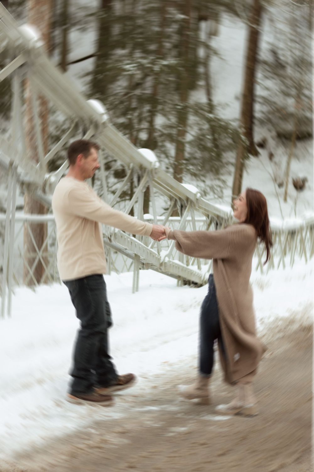 A sequence of motion showing two people playfully throwing pillows at each other in a snowy winter setting.
