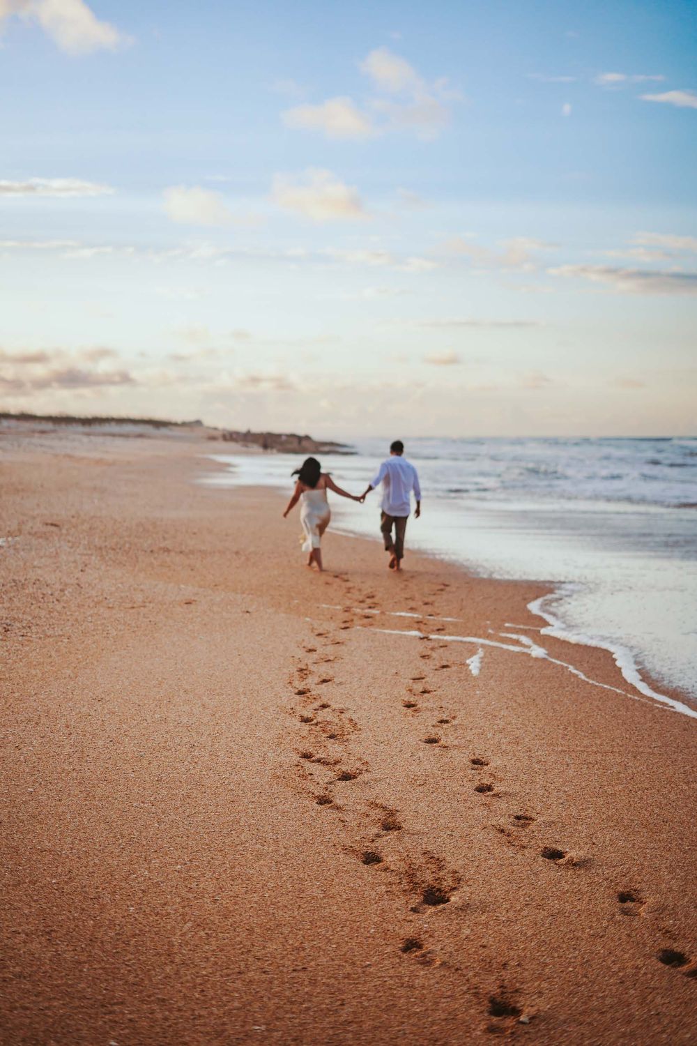Photoshoot at Washington Oaks Gardens State Park Palm Coast Florida. Engagement photos of a couple walking on the beach at golden hour.