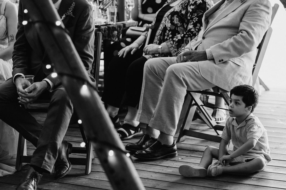 Black and white photo sequence showing people dancing and celebrating at what appears to be a wedding reception.