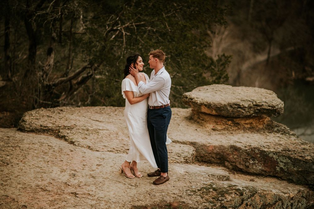 Bride and groom cuddling at the viewpoint of a hike after their elopement ceremony in Nashville, Tn.
