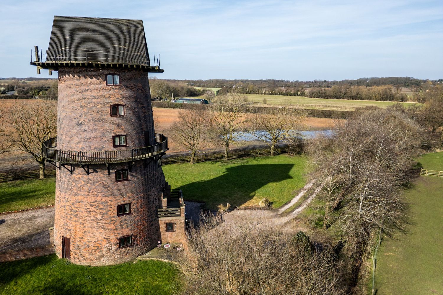 Historic brick windmill at Windmill Farm Burscough surrounded by Lancashire fields on a clear countryside wedding day