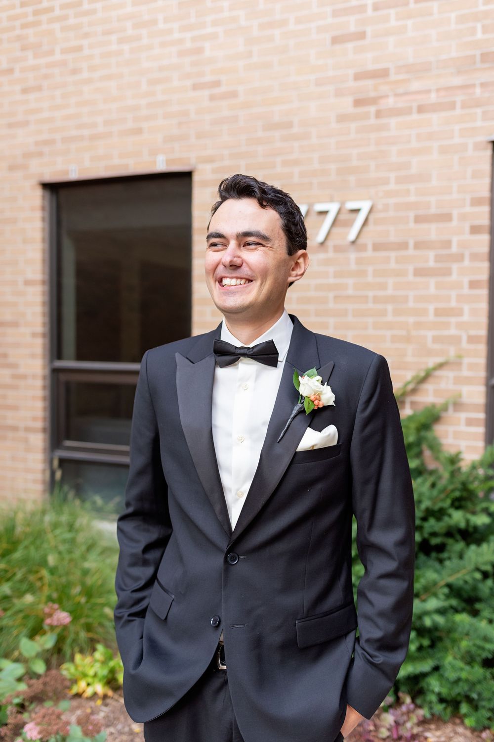 A sequence of joyful expressions captured against a brick wall background at a formal event.