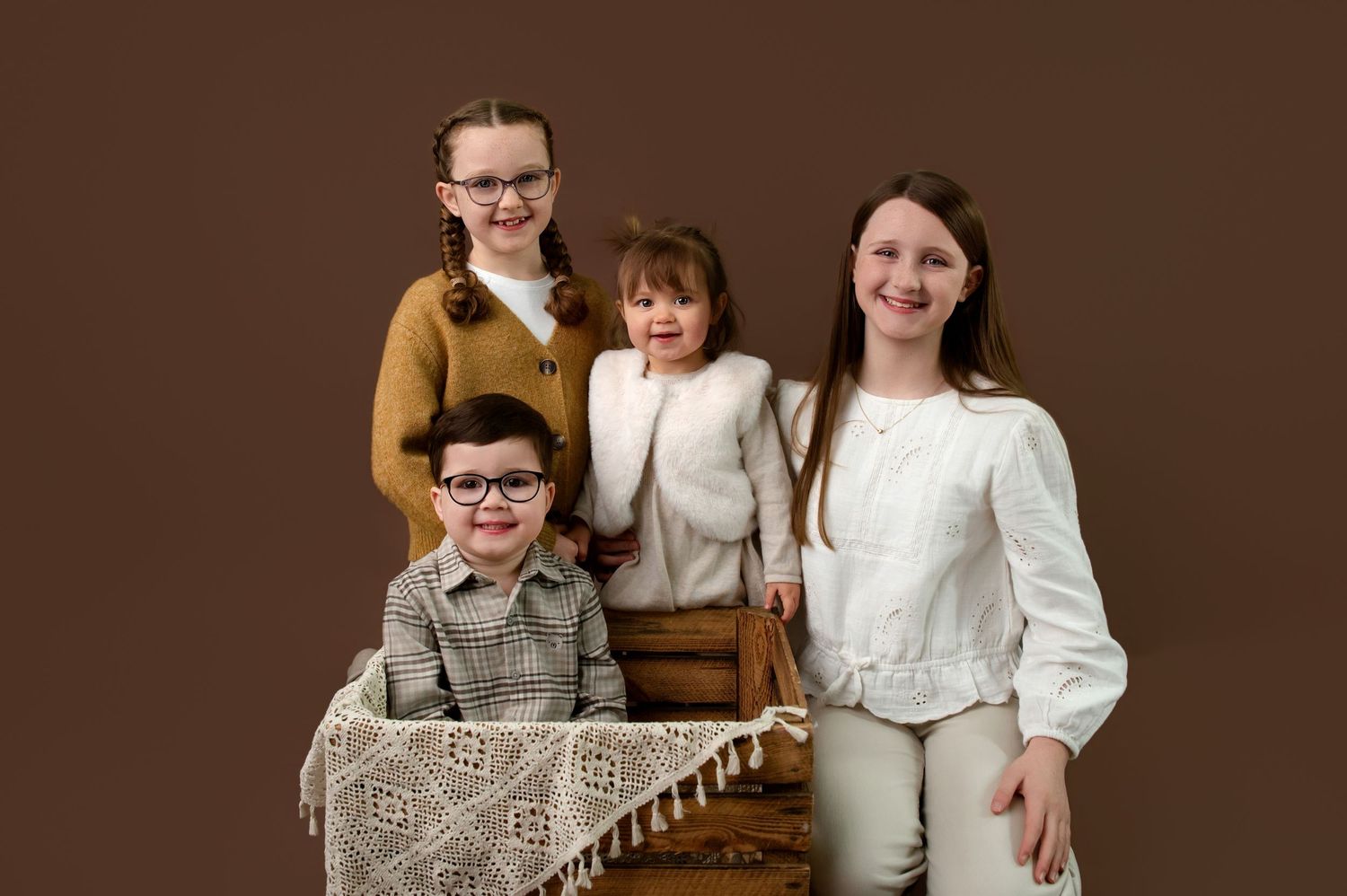 A series of vintage-style family portraits in warm brown tones showing different poses and groupings.