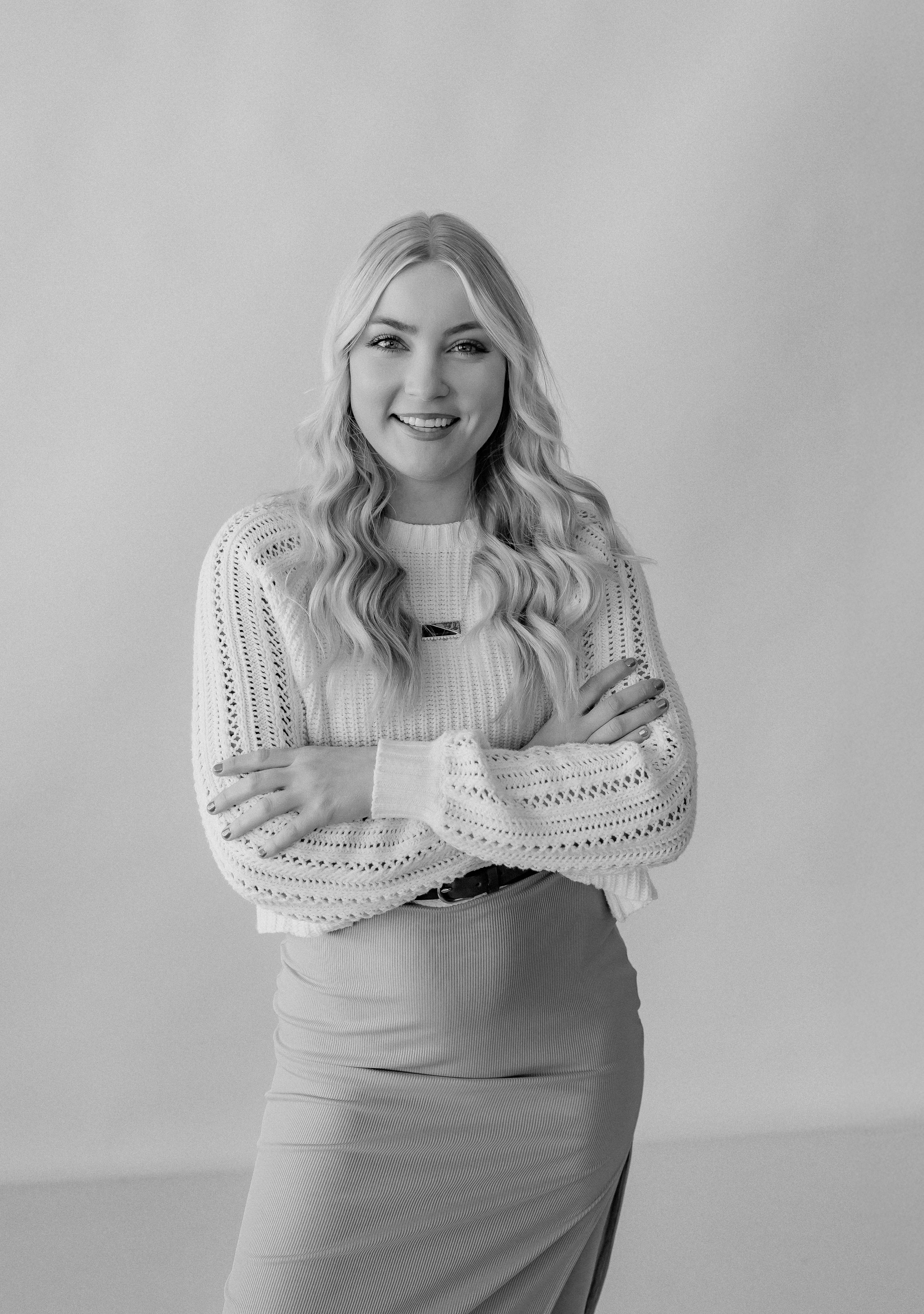 Monochrome studio portrait featuring textured sweater and elegant pose.