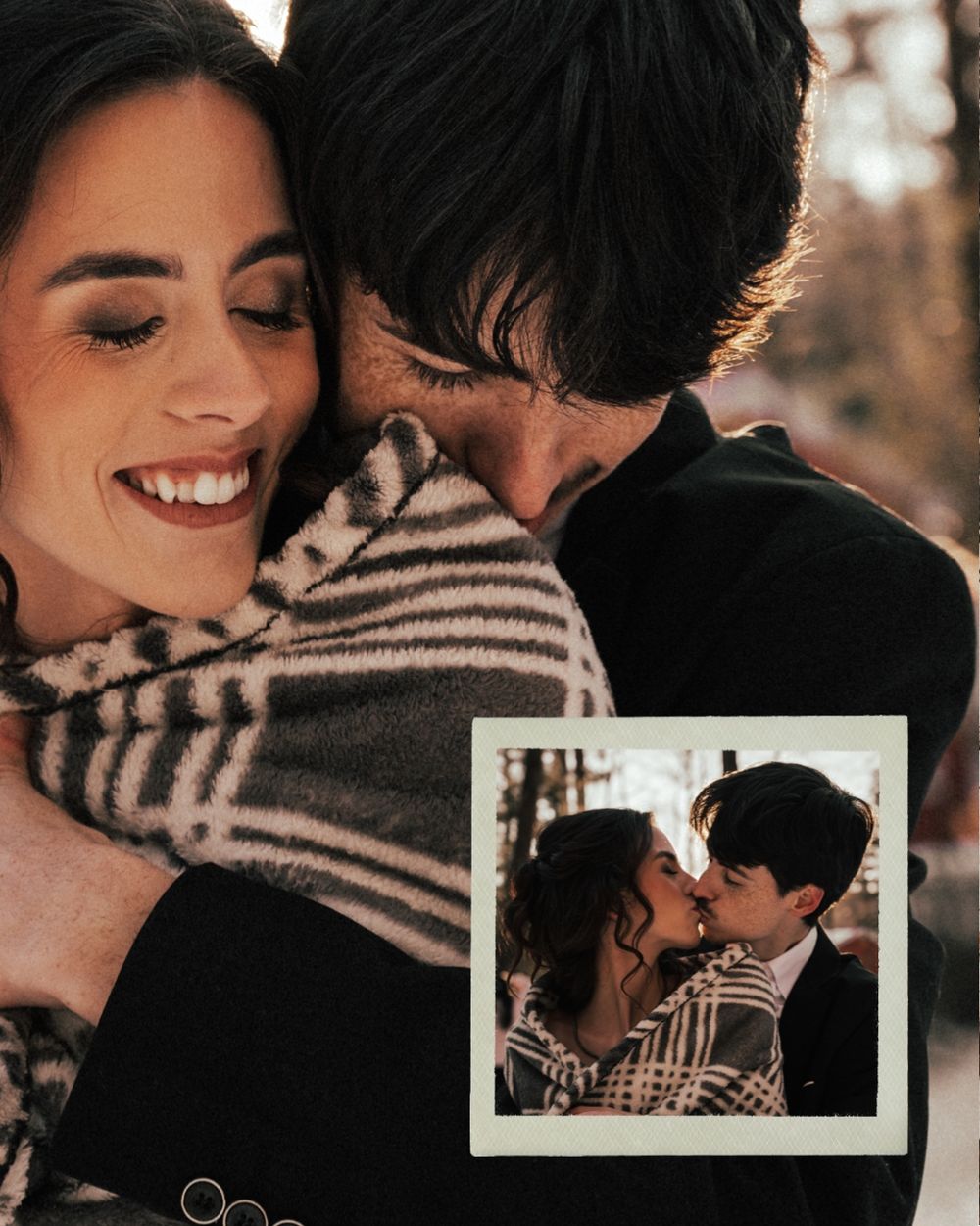 A romantic couple embraces while holding a polaroid photo of themselves in a warm autumn setting.