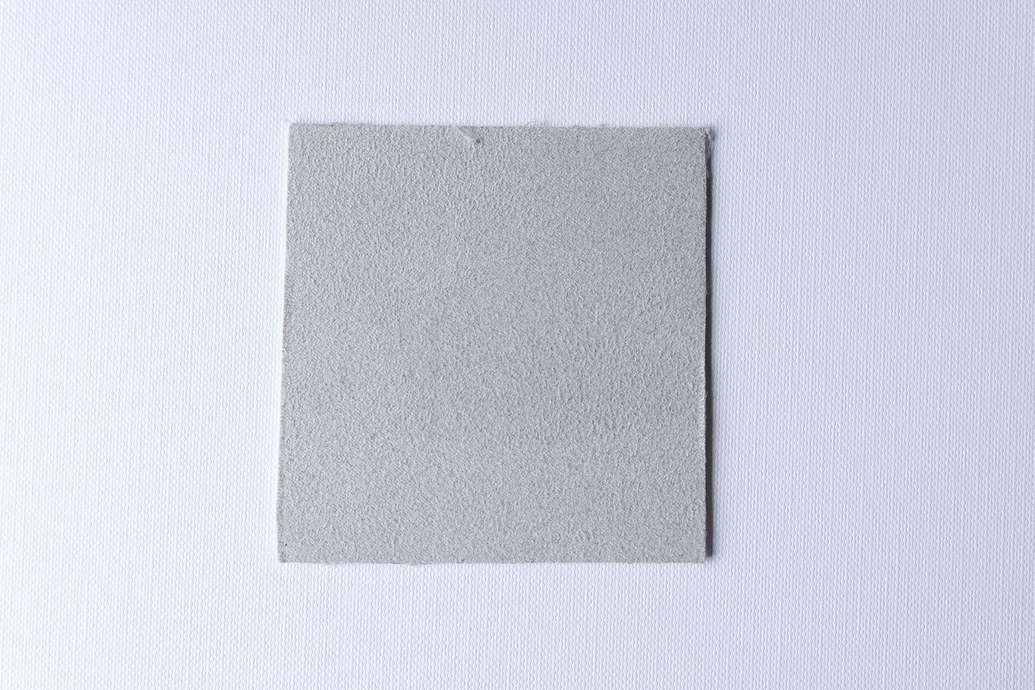 Several pieces of blue denim fabric samples arranged in a row against a light gray background.