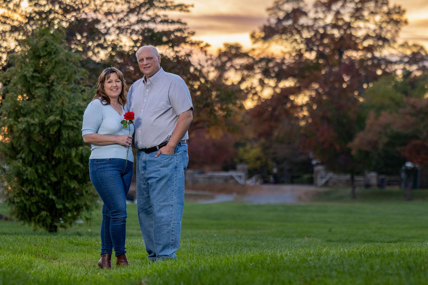 Frederick Maryland Wedding Photographer     A couple walks together through a park at sunset during their photo session.