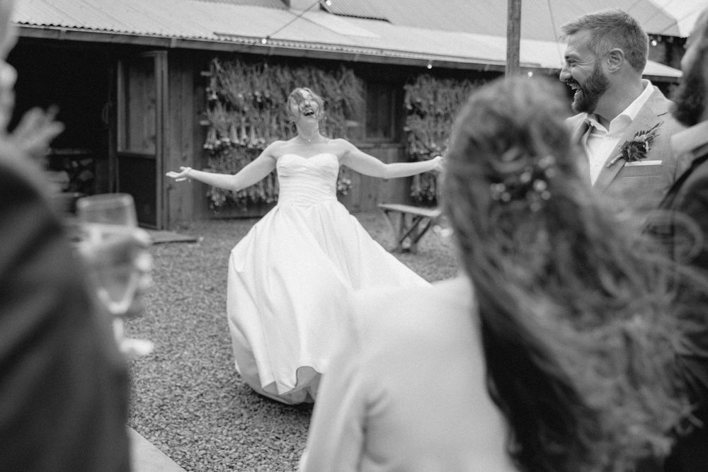 A black and white collage of wedding moments showing dancing, laughter and celebration at an outdoor reception.