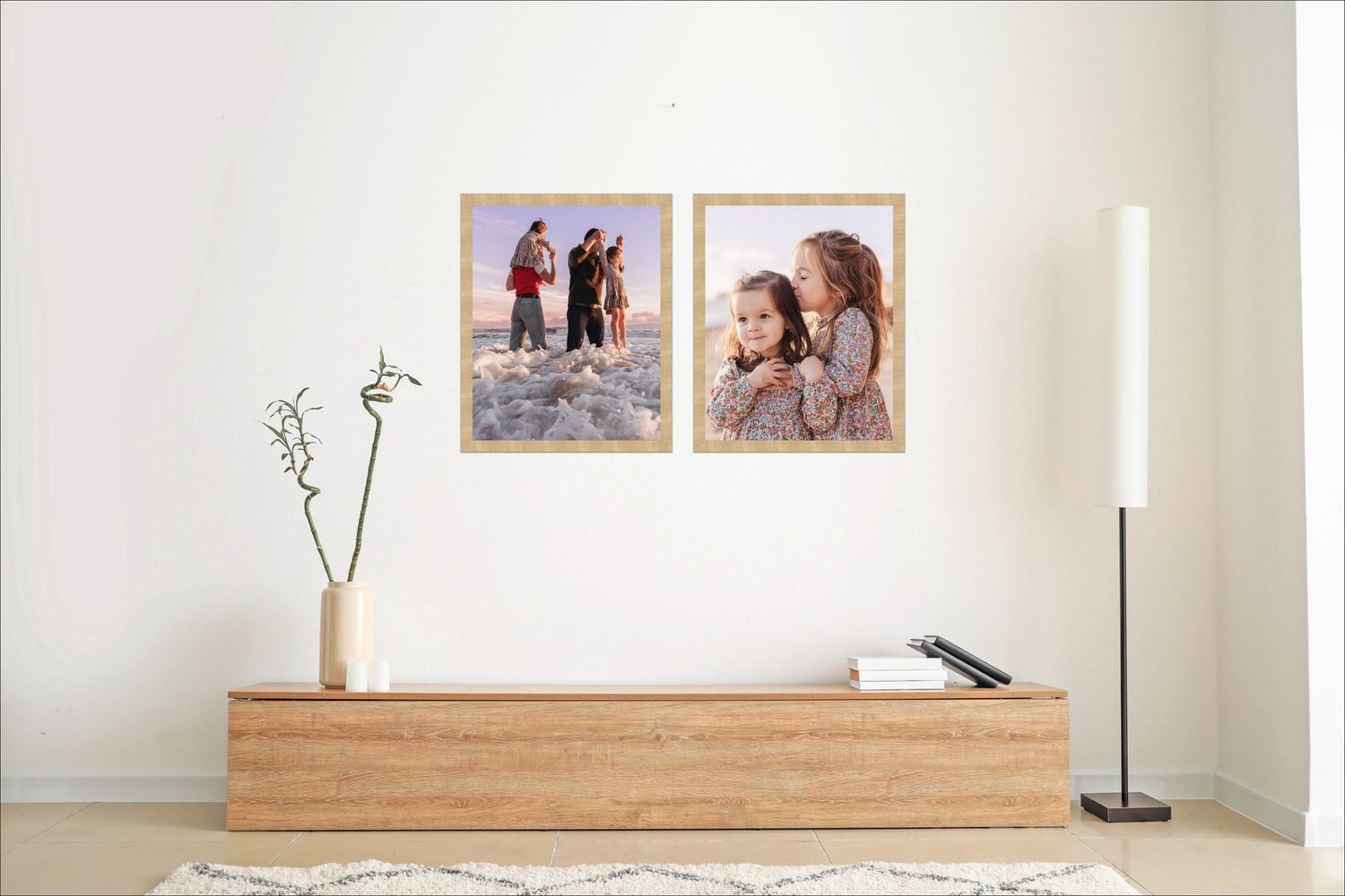 A cozy living room wall displays six framed photographs in a grid arrangement above a beige sofa with throw pillows.