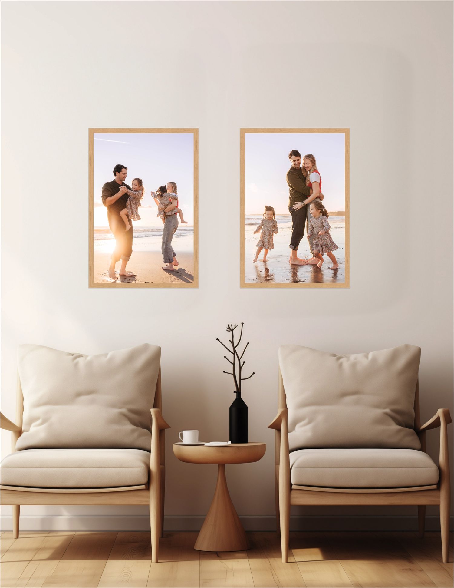 A modern minimalist living room features a beige armchair with wooden frame against a light gray wall with framed artwork.