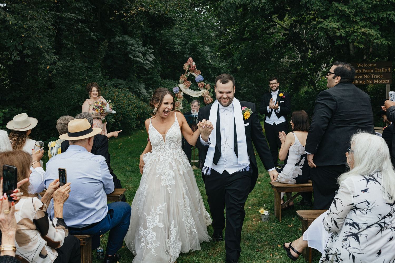 Happy couple who was just married walking down the aisle win the Hudson Valley