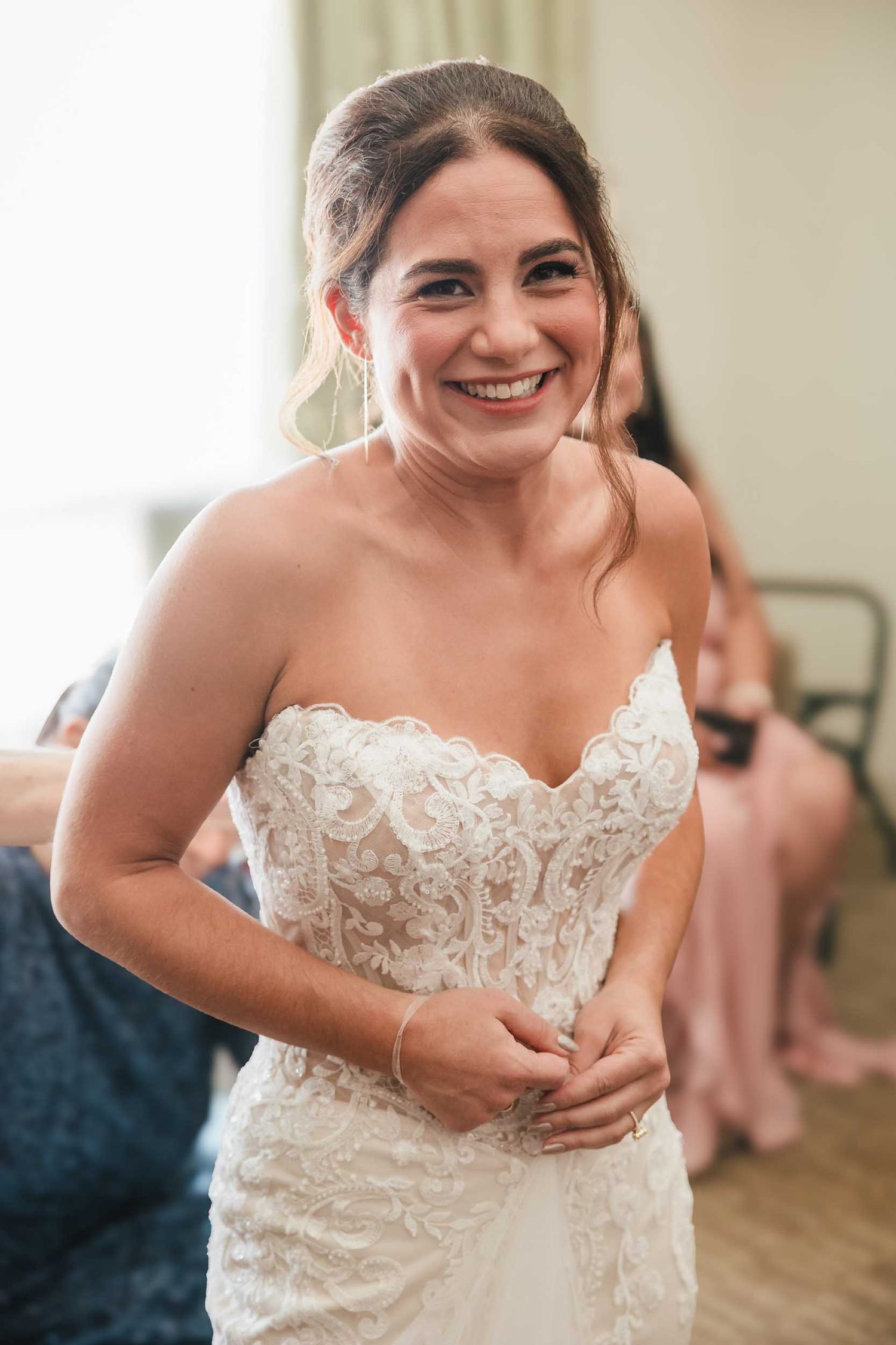 Bride smiling in her lace wedding dress during getting ready at a Boston wedding