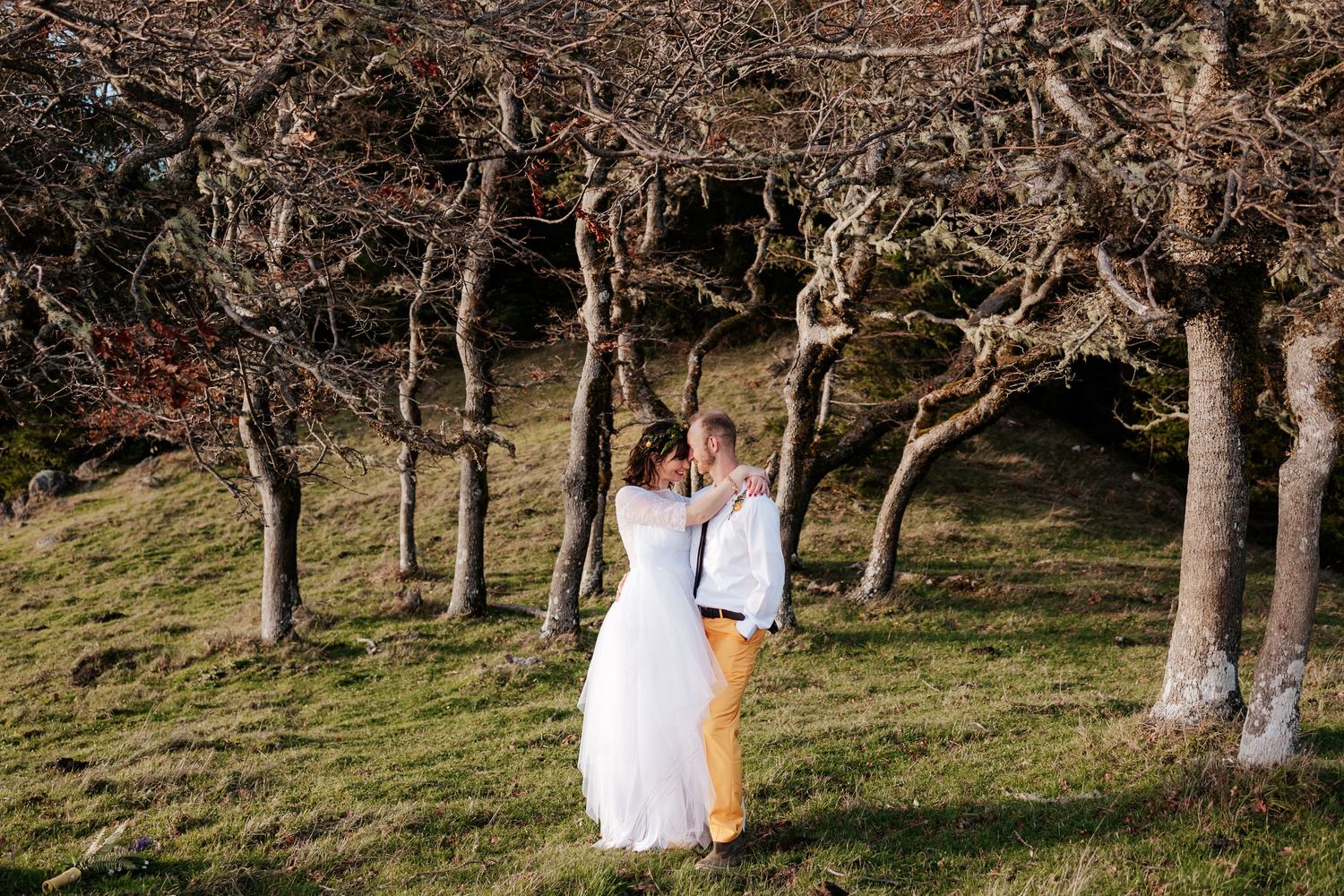 Taylor Carpenter Photography takes photo of bride and groom happy as can be in a grove of trees