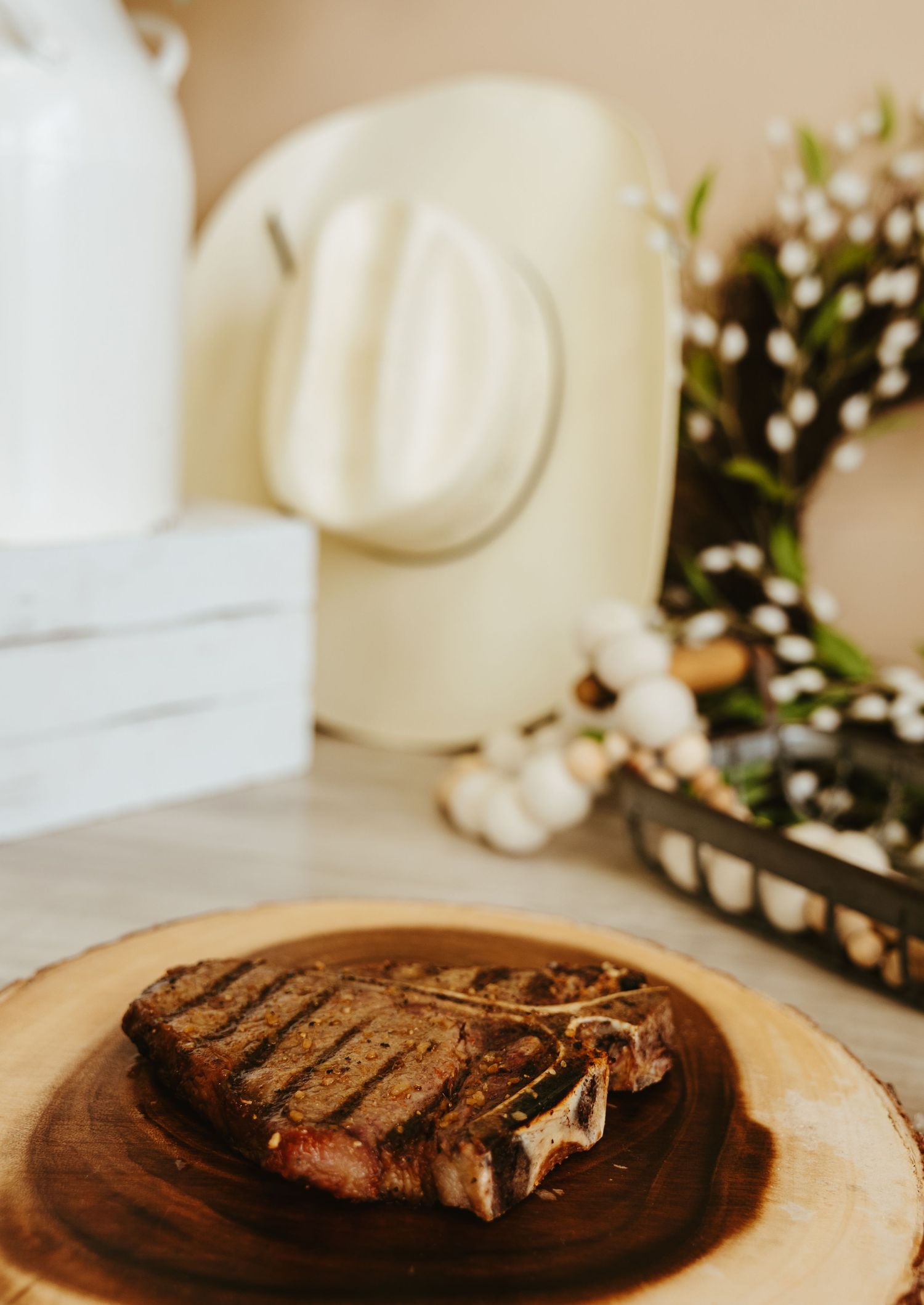 Grilled cheese sandwich on wooden serving board with flowers in background.