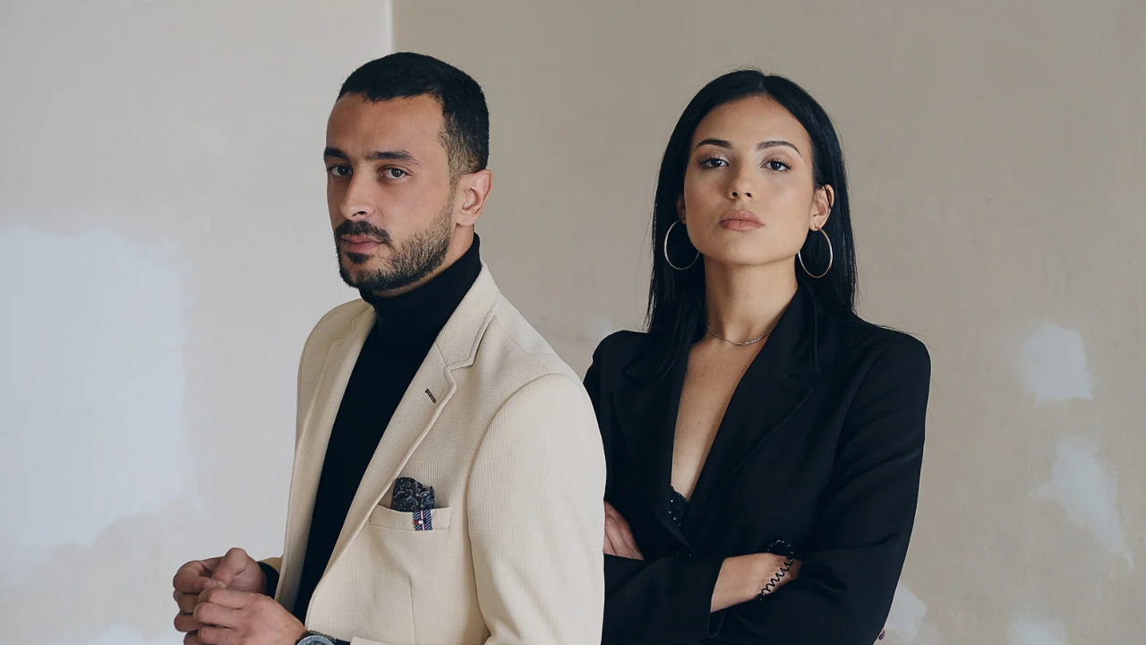 A white male and female professional on milk suit and black suit , professional pieces for the office